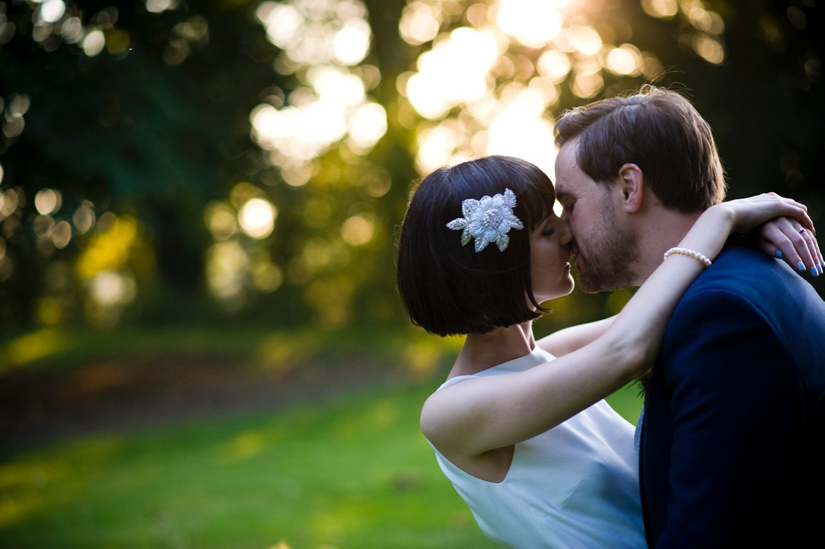 Bride Alice wore a chic, Charlie Brear column style gown for her 1920's and books/literary inspired summer barn wedding. Images by Richard Beaumont.