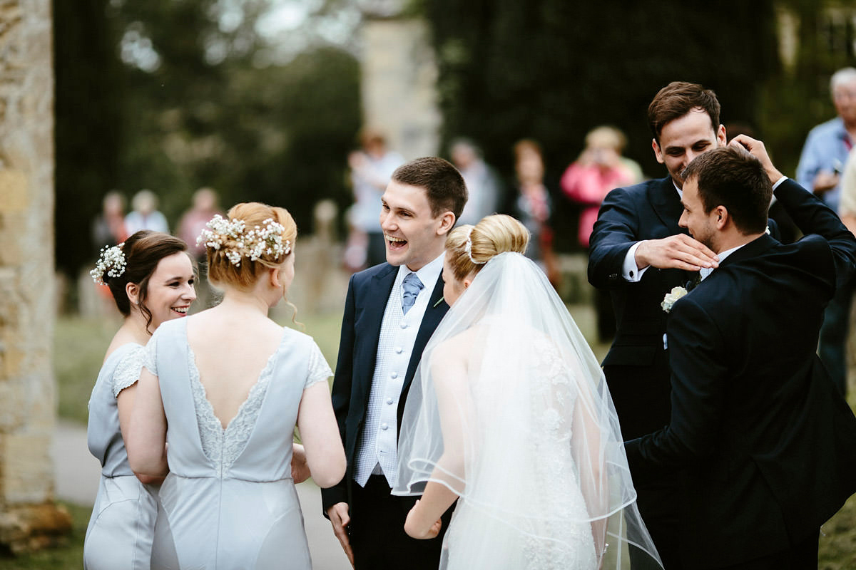 An elegant halterneck dress and bridesmaids in pale blue for a stylish English country wedding. Captured by Ruth Atkins Photography. An elegant halterneck dress and bridesmaids in pale blue for a stylish English country wedding. Captured by Ruth Atkins Photography.