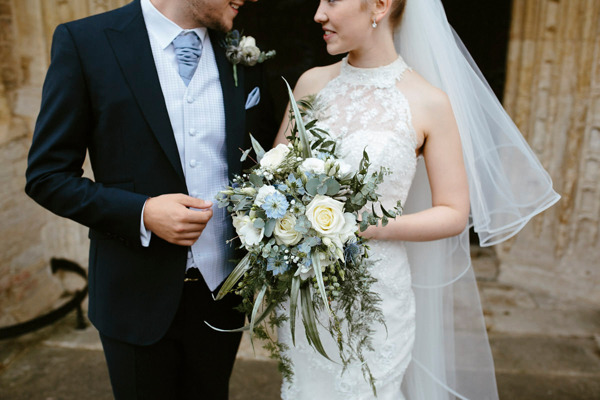 An elegant halterneck dress and bridesmaids in pale blue for a stylish English country wedding. Captured by Ruth Atkins Photography. An elegant halterneck dress and bridesmaids in pale blue for a stylish English country wedding. Captured by Ruth Atkins Photography.