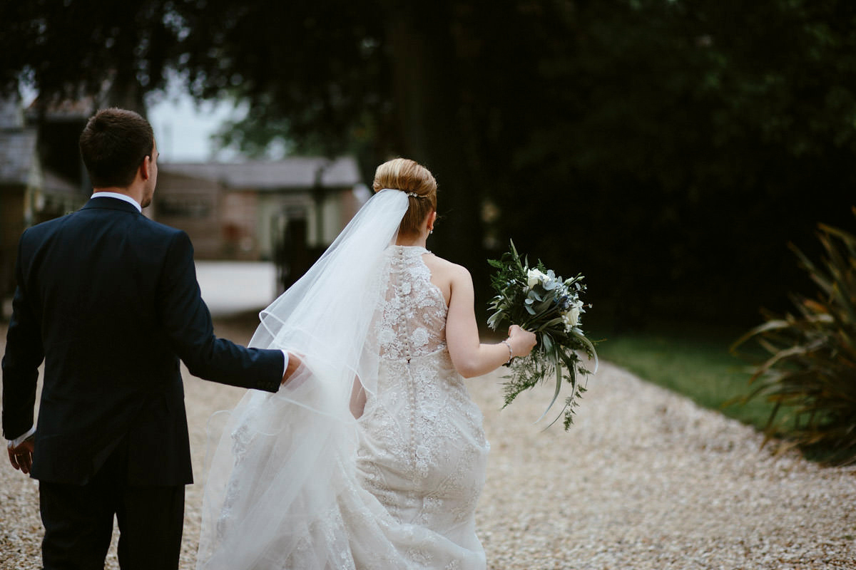 An elegant halterneck dress and bridesmaids in pale blue for a stylish English country wedding. Captured by Ruth Atkins Photography. An elegant halterneck dress and bridesmaids in pale blue for a stylish English country wedding. Captured by Ruth Atkins Photography.