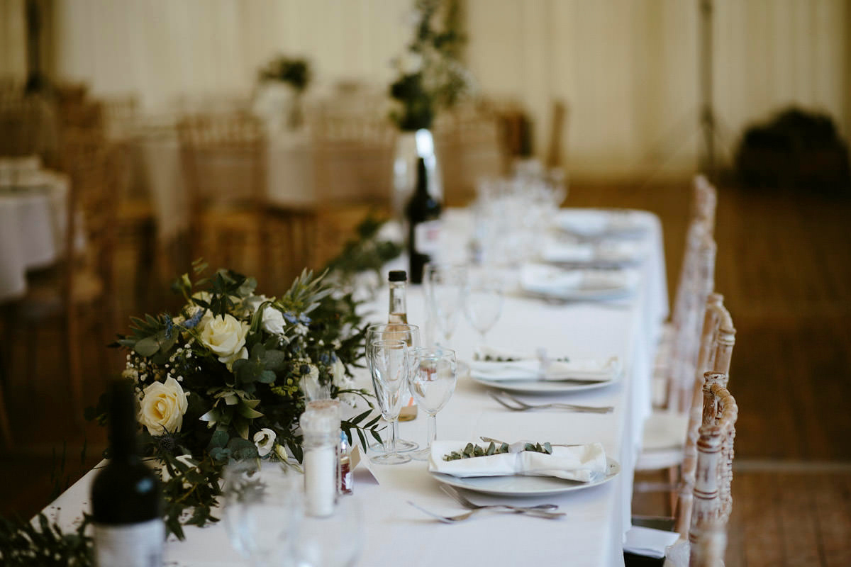 An elegant halterneck dress and bridesmaids in pale blue for a stylish English country wedding. Captured by Ruth Atkins Photography. An elegant halterneck dress and bridesmaids in pale blue for a stylish English country wedding. Captured by Ruth Atkins Photography.