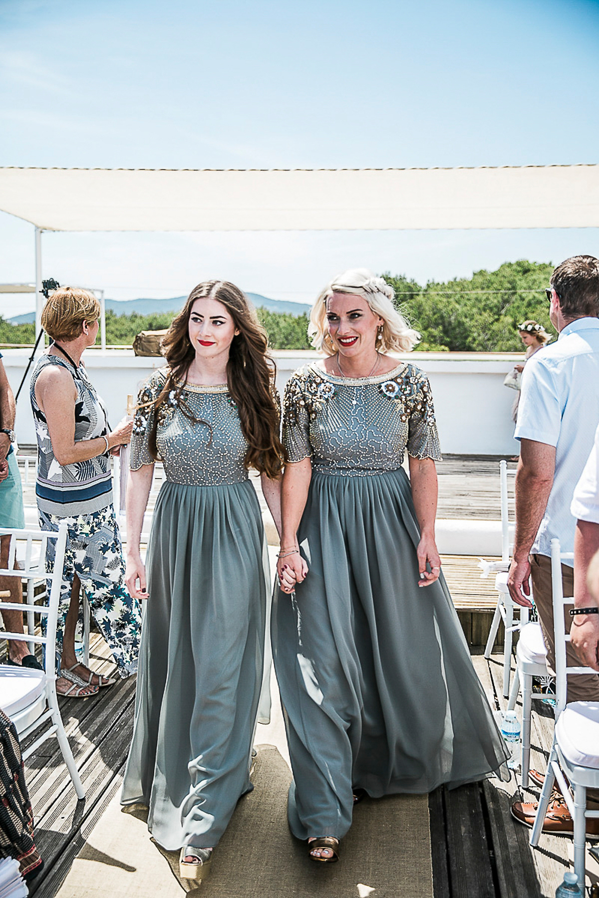 Karen wore an Enzoani gown for her Ibiza destination wedding, her bridesmaids wore Virgos Lounge floor length beaded gowns. Photography by Samie Lee.