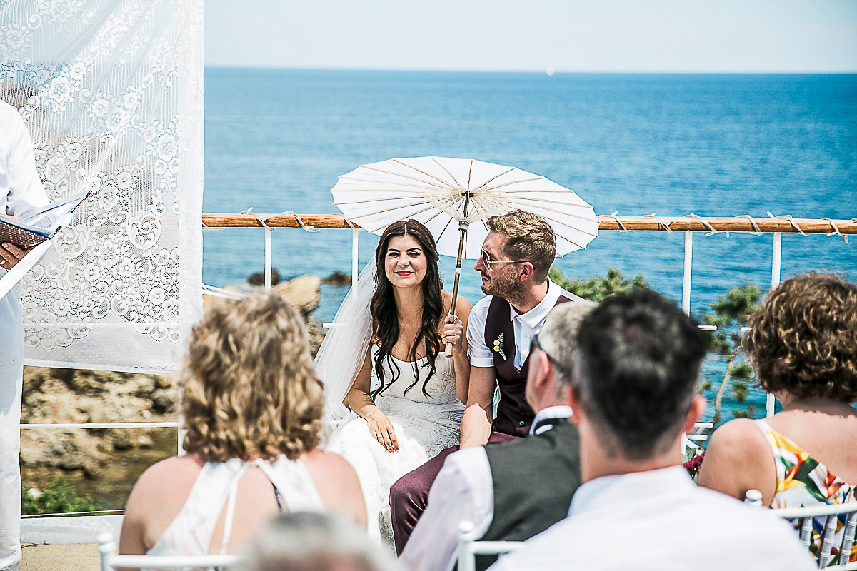 Karen wore an Enzoani gown for her Ibiza destination wedding, her bridesmaids wore Virgos Lounge floor length beaded gowns. Photography by Samie Lee.