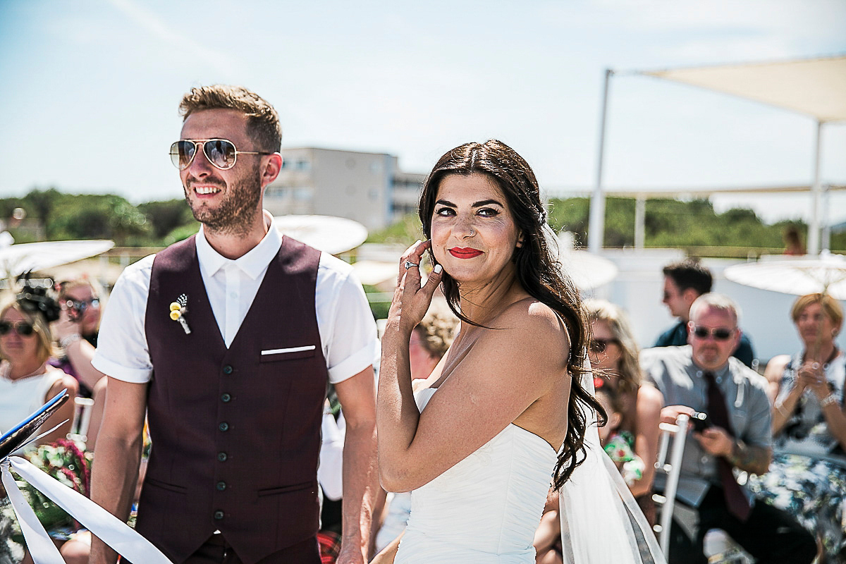 Karen wore an Enzoani gown for her Ibiza destination wedding, her bridesmaids wore Virgos Lounge floor length beaded gowns. Photography by Samie Lee.