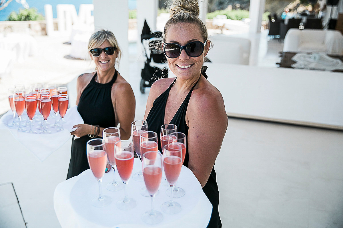 Karen wore an Enzoani gown for her Ibiza destination wedding, her bridesmaids wore Virgos Lounge floor length beaded gowns. Photography by Samie Lee.