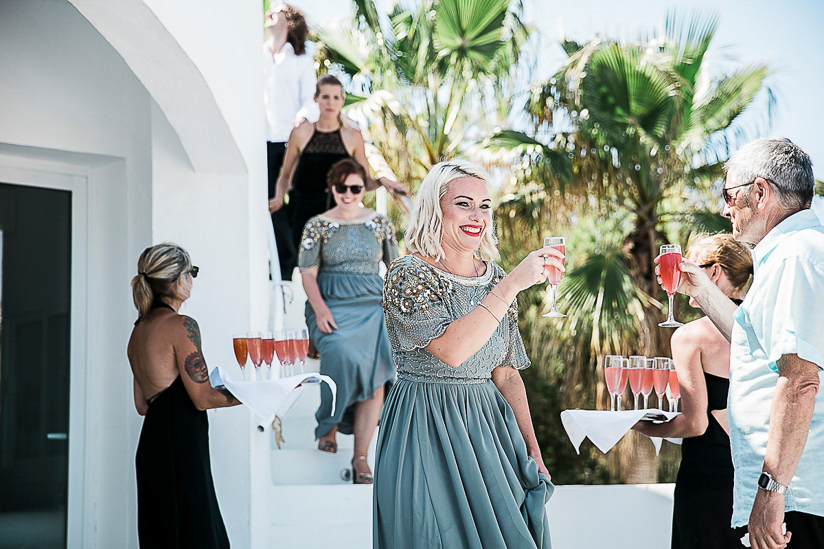 Karen wore an Enzoani gown for her Ibiza destination wedding, her bridesmaids wore Virgos Lounge floor length beaded gowns. Photography by Samie Lee.