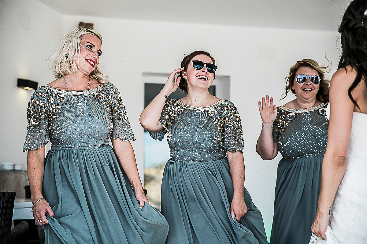 Karen wore an Enzoani gown for her Ibiza destination wedding, her bridesmaids wore Virgos Lounge floor length beaded gowns. Photography by Samie Lee.