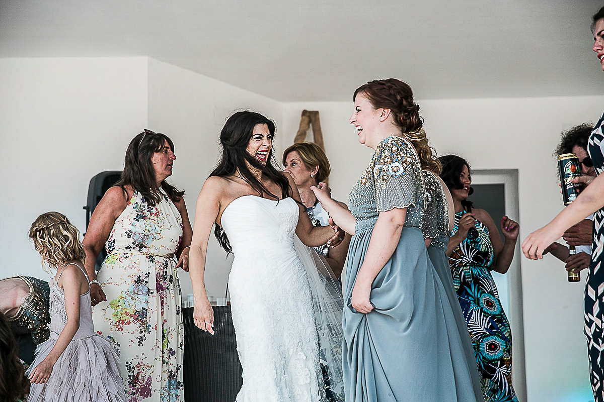 Karen wore an Enzoani gown for her Ibiza destination wedding, her bridesmaids wore Virgos Lounge floor length beaded gowns. Photography by Samie Lee.