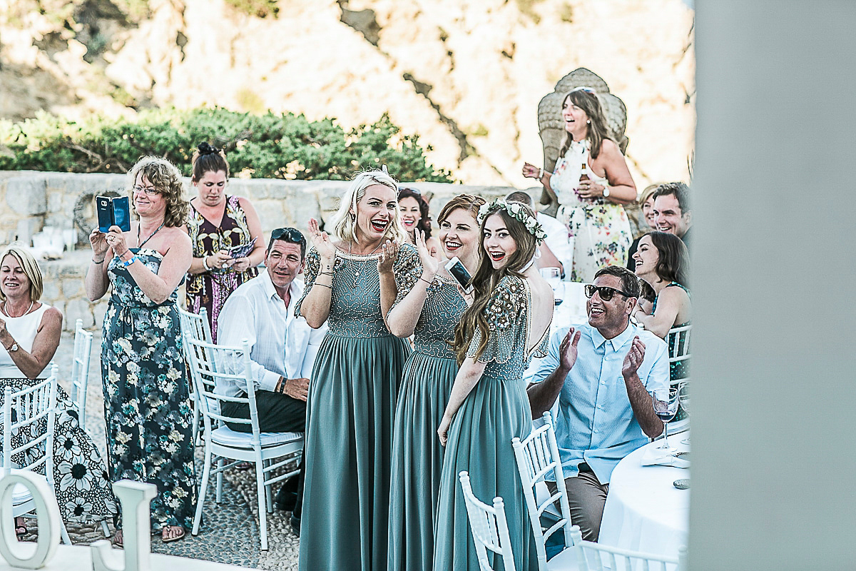 Karen wore an Enzoani gown for her Ibiza destination wedding, her bridesmaids wore Virgos Lounge floor length beaded gowns. Photography by Samie Lee.