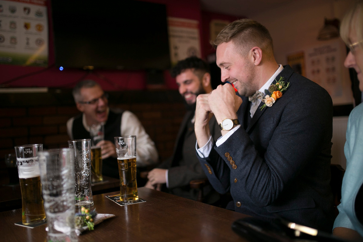 Bride Laura wore a Charlie Brear gown and floral crown for her charming Autumn village hall wedding. Photography by Henry Britten.