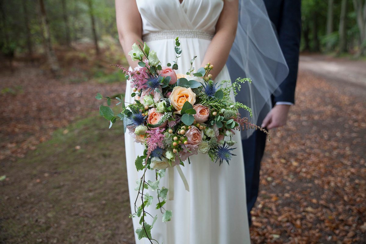 Bride Laura wore a Charlie Brear gown and floral crown for her charming Autumn village hall wedding. Photography by Henry Britten.