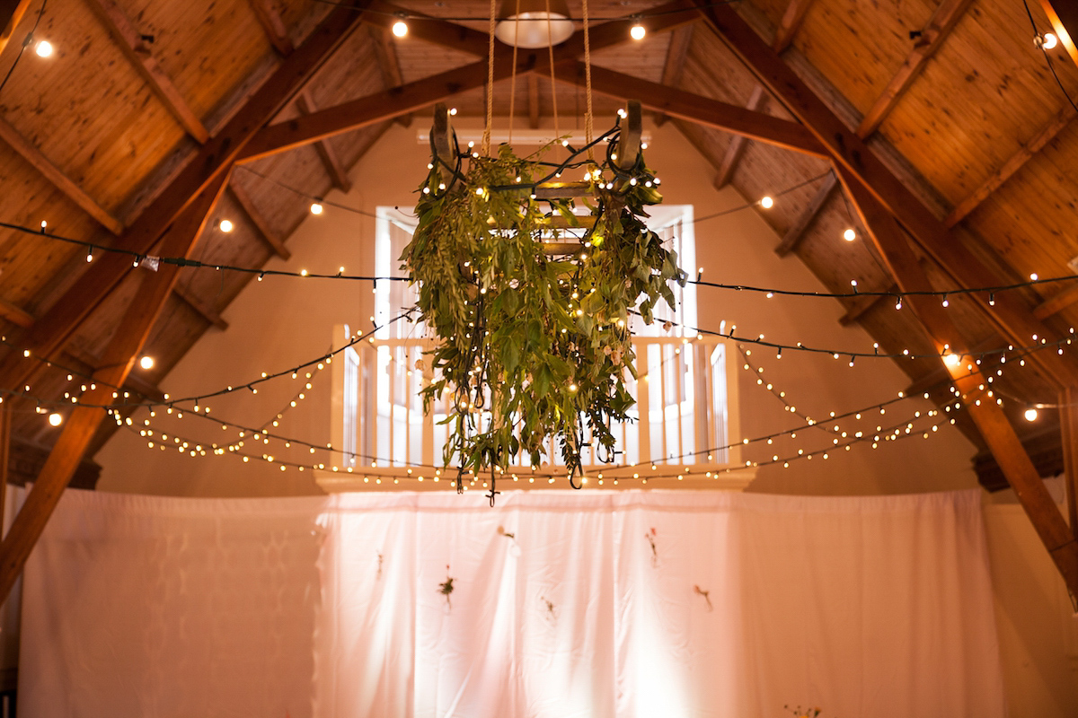 Bride Laura wore a Charlie Brear gown and floral crown for her charming Autumn village hall wedding. Photography by Henry Britten.