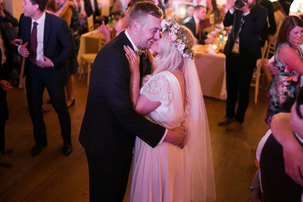 Bride Laura wore a Charlie Brear gown and floral crown for her charming Autumn village hall wedding. Photography by Henry Britten.