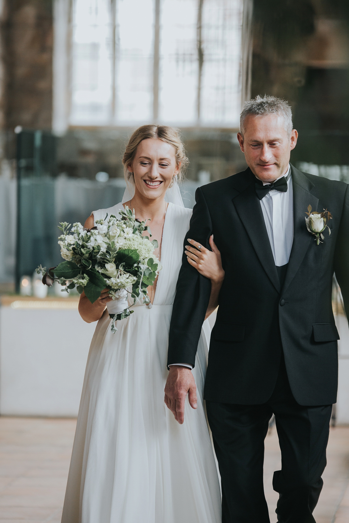 Barefoot bride Zoё wore a dress she had designed herself for her effortlessly elegant wedding at Blackfriar medieval priory in Gloucester. Captured by Grace Elizabeth Photography.