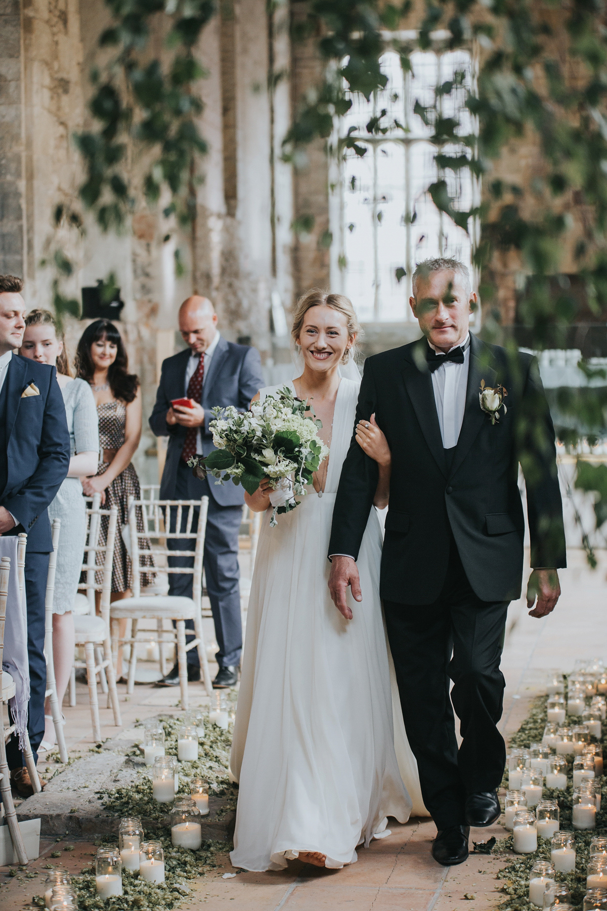 Barefoot bride Zoё wore a dress she had designed herself for her effortlessly elegant wedding at Blackfriar medieval priory in Gloucester. Captured by Grace Elizabeth Photography.