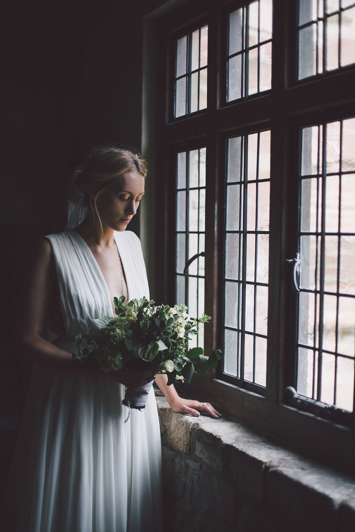 Barefoot bride Zoё wore a dress she had designed herself for her effortlessly elegant wedding at Blackfriar medieval priory in Gloucester. Captured by Grace Elizabeth Photography.