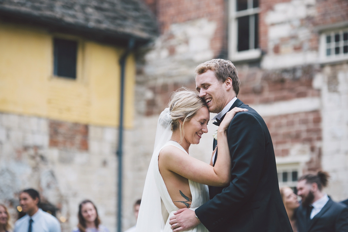 Barefoot bride Zoё wore a dress she had designed herself for her effortlessly elegant wedding at Blackfriar medieval priory in Gloucester. Captured by Grace Elizabeth Photography.