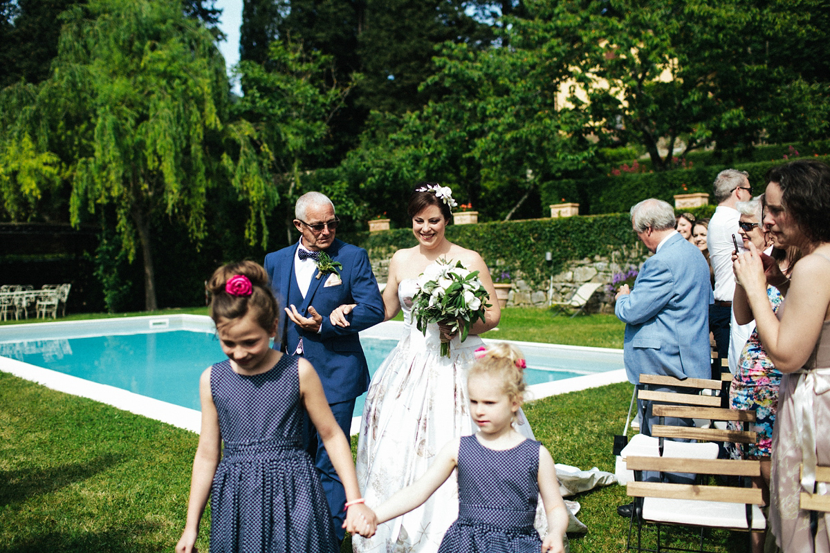 Bride Lucy wore a gold floral Vera Wang gown for her romantic outdoor wedding in the Italian countryside. Images captured by Claudia Rose Carter.