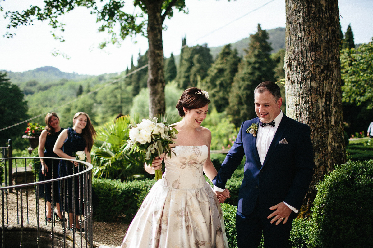 Bride Lucy wore a gold floral Vera Wang gown for her romantic outdoor wedding in the Italian countryside. Images captured by Claudia Rose Carter.