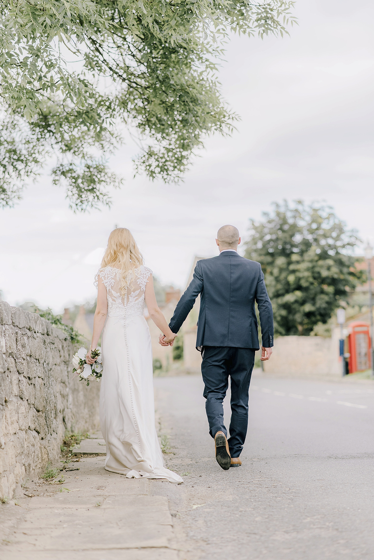 Dani wore a Justin Alexander gown for her relaxed and romantic English country wedding. Fine art film photography by Georgina Harrison.