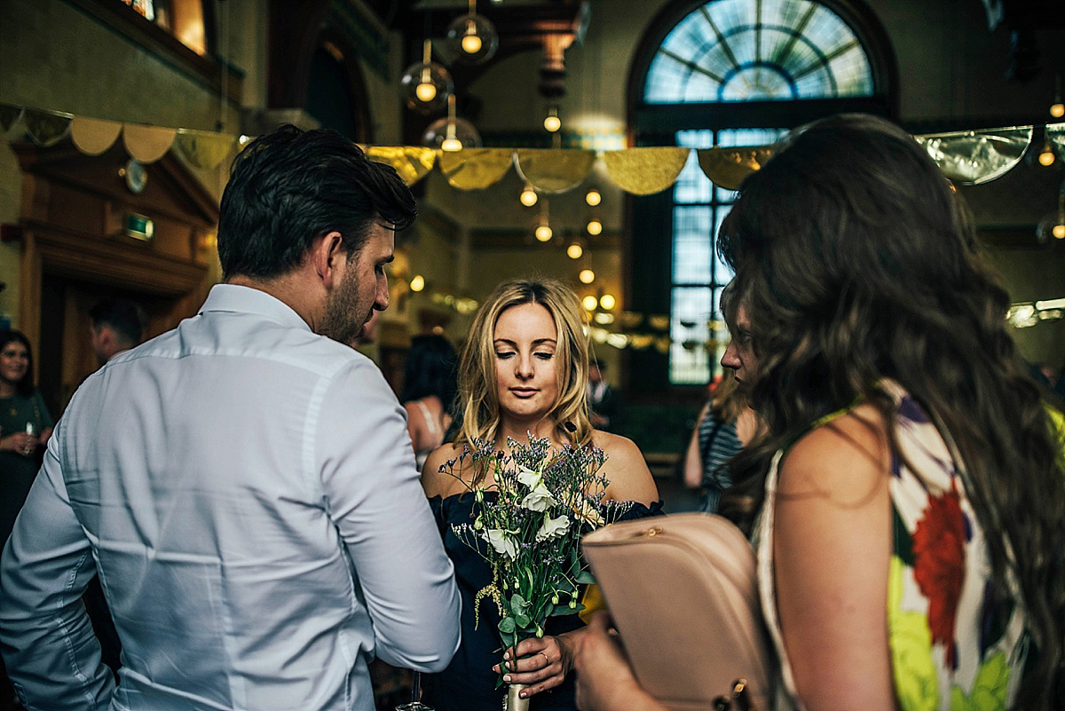 Bride Amelia wore a pale blue/grey Self Portrait dress for her handmade and stripped back, non traditional wedding. Captured by Three Flowers Photography.