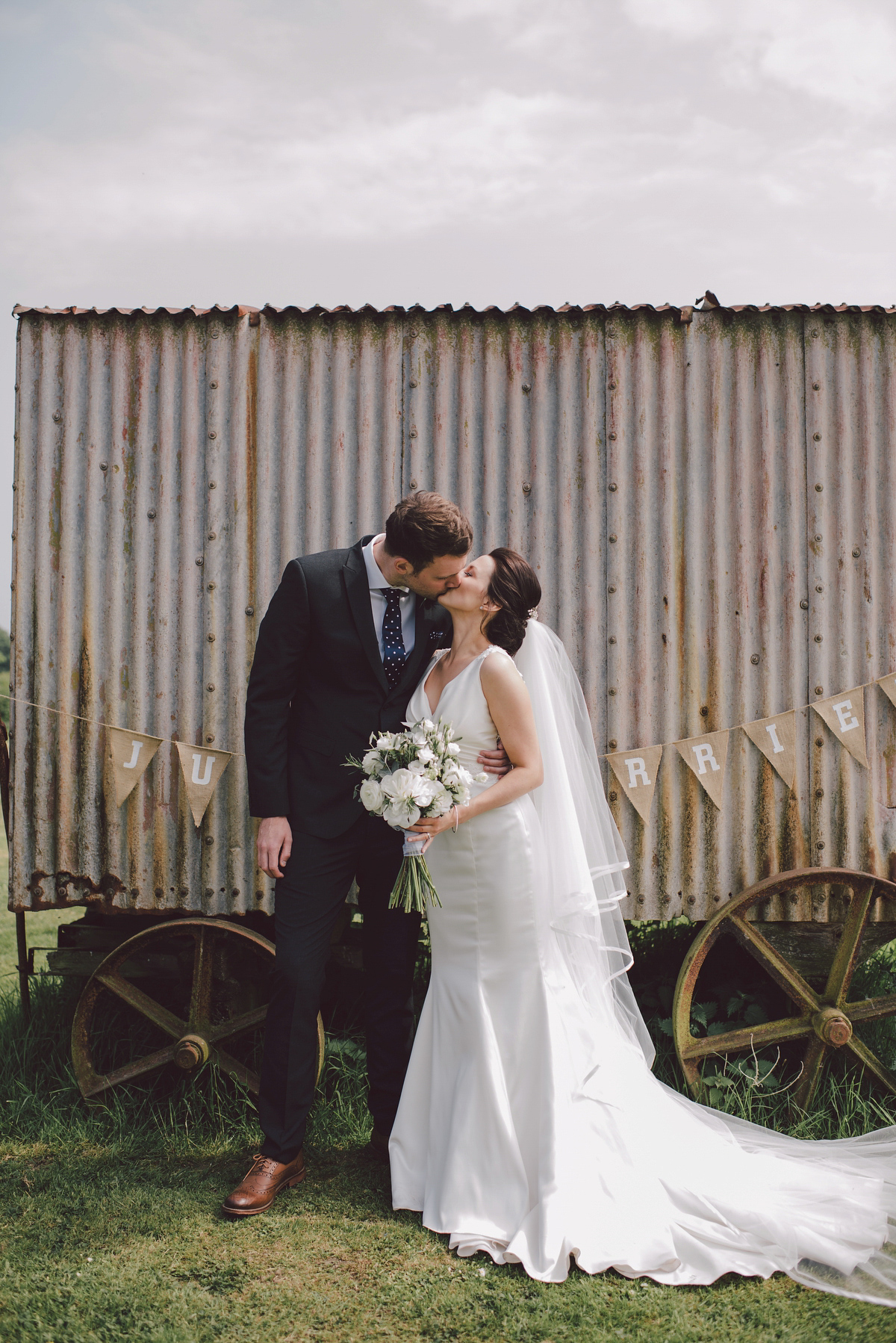 Bride Nina wore a Sincerity gown for her rustic and handmade Spring country barn wedding. Photography by Roberta Matis.
