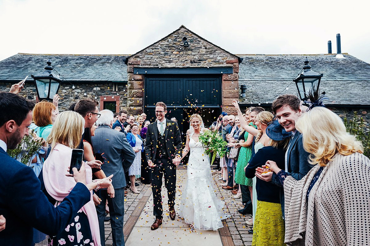 Beautiful bride Clare wore the Mariposa gown by Claire Pettibone for her laid back, fun and elegant Lake District Wedding. Photography by Lisa Aldersley.