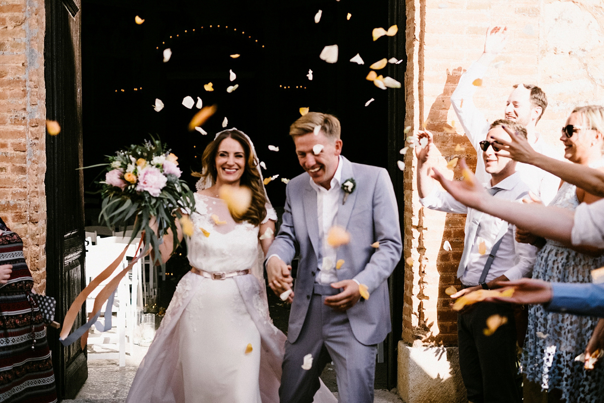 Bride Laura wears a bespoke wedding dress by Wilden Bride for her elegant destination wedding in Spain. Photography by Claudia Rose Carter.