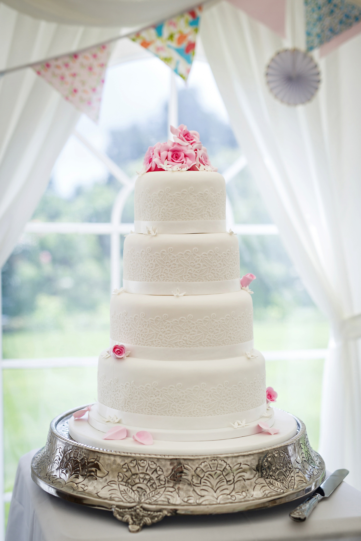 Emily wore Jenny Packham's 'Aspen' gown for her quintessentially English country house wedding in pastel shades.