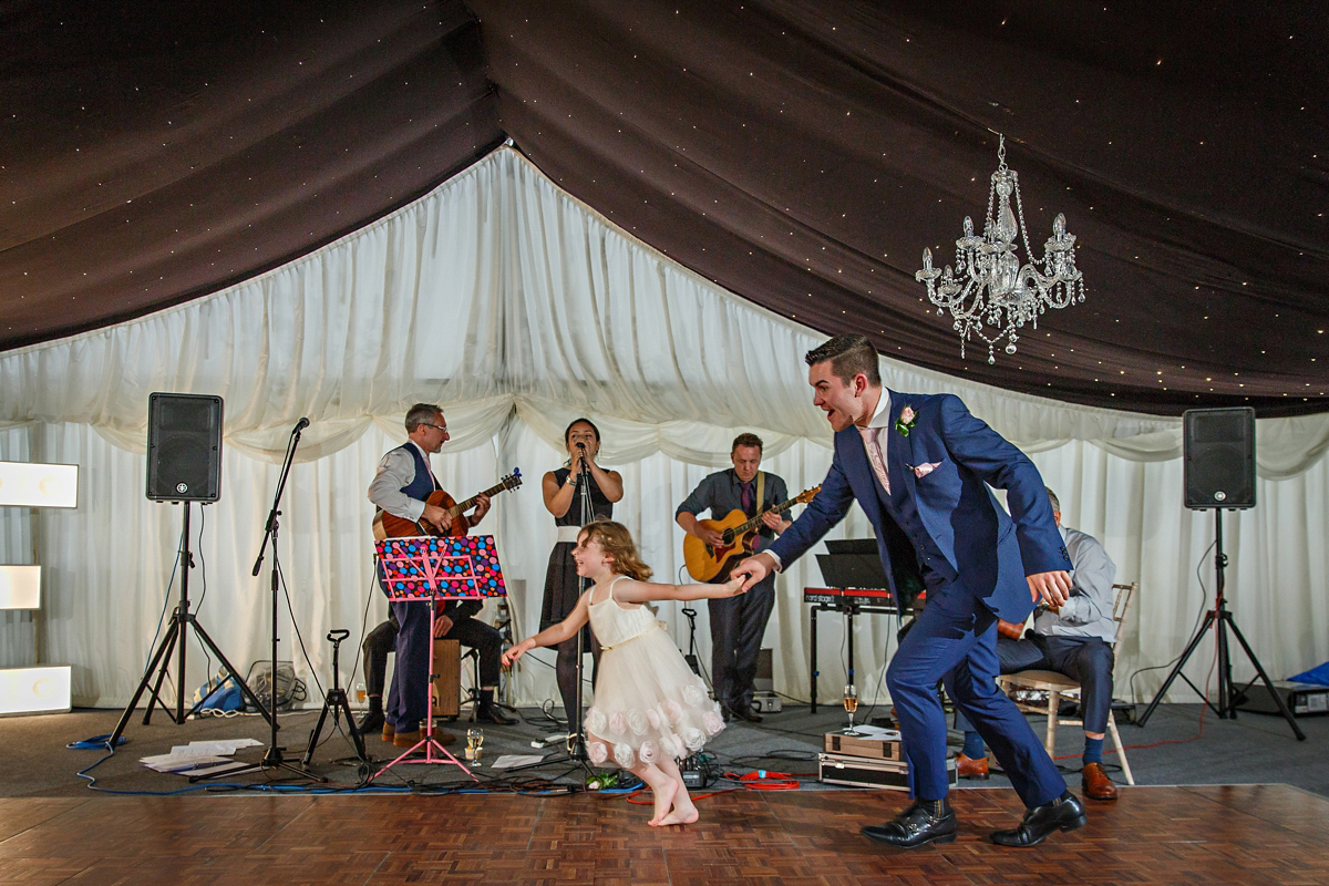 Emily wore Jenny Packham's 'Aspen' gown for her quintessentially English country house wedding in pastel shades.