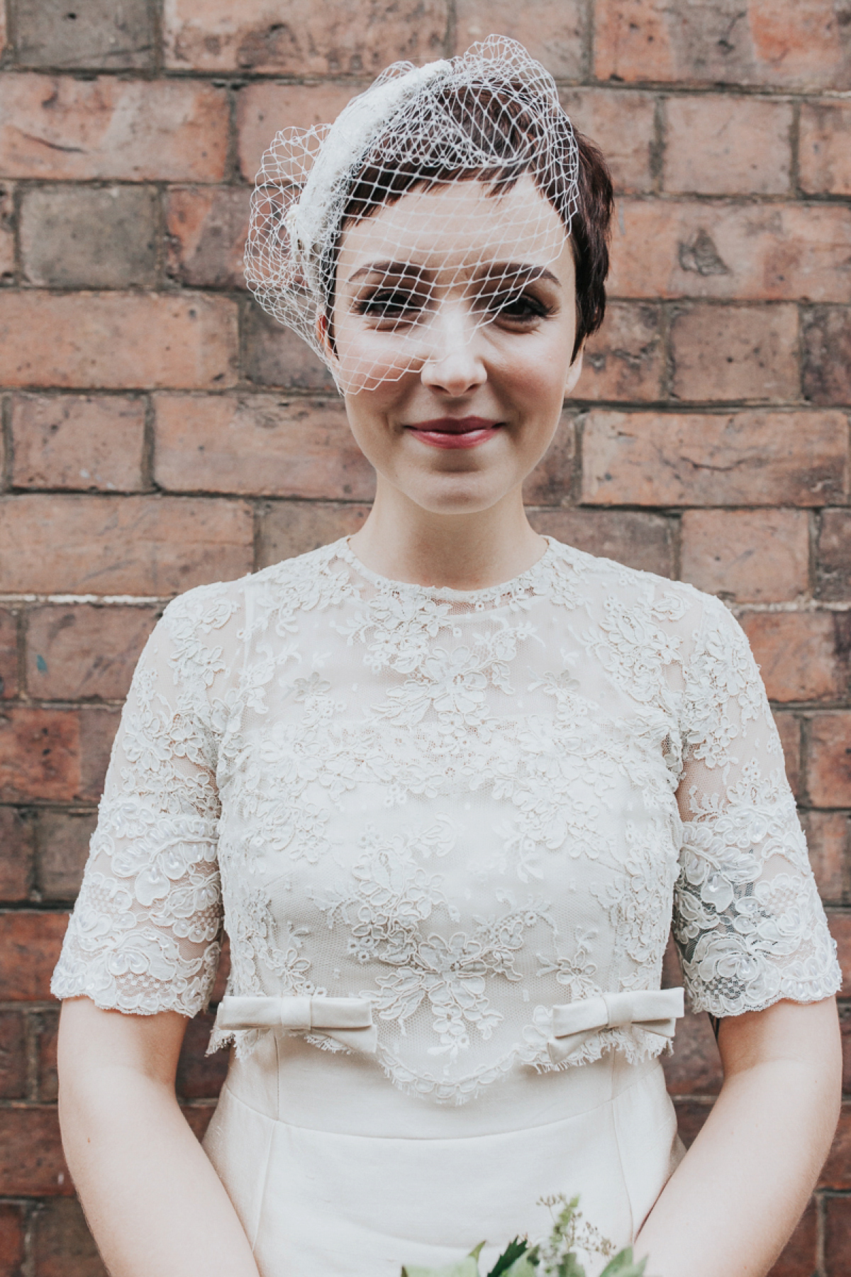 A short wedding dress and birdcage veil for a 1960's inspired bride. Image by Indie Photography.
