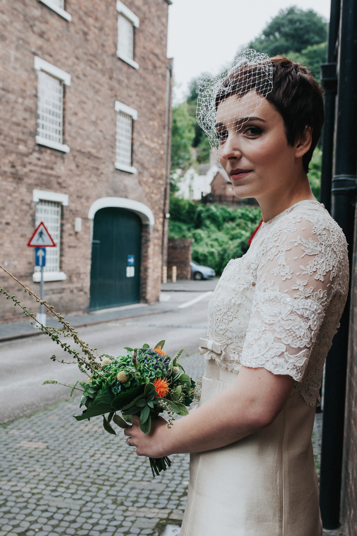 A short wedding dress and birdcage veil for a 1960's inspired bride. Image by Indie Photography.