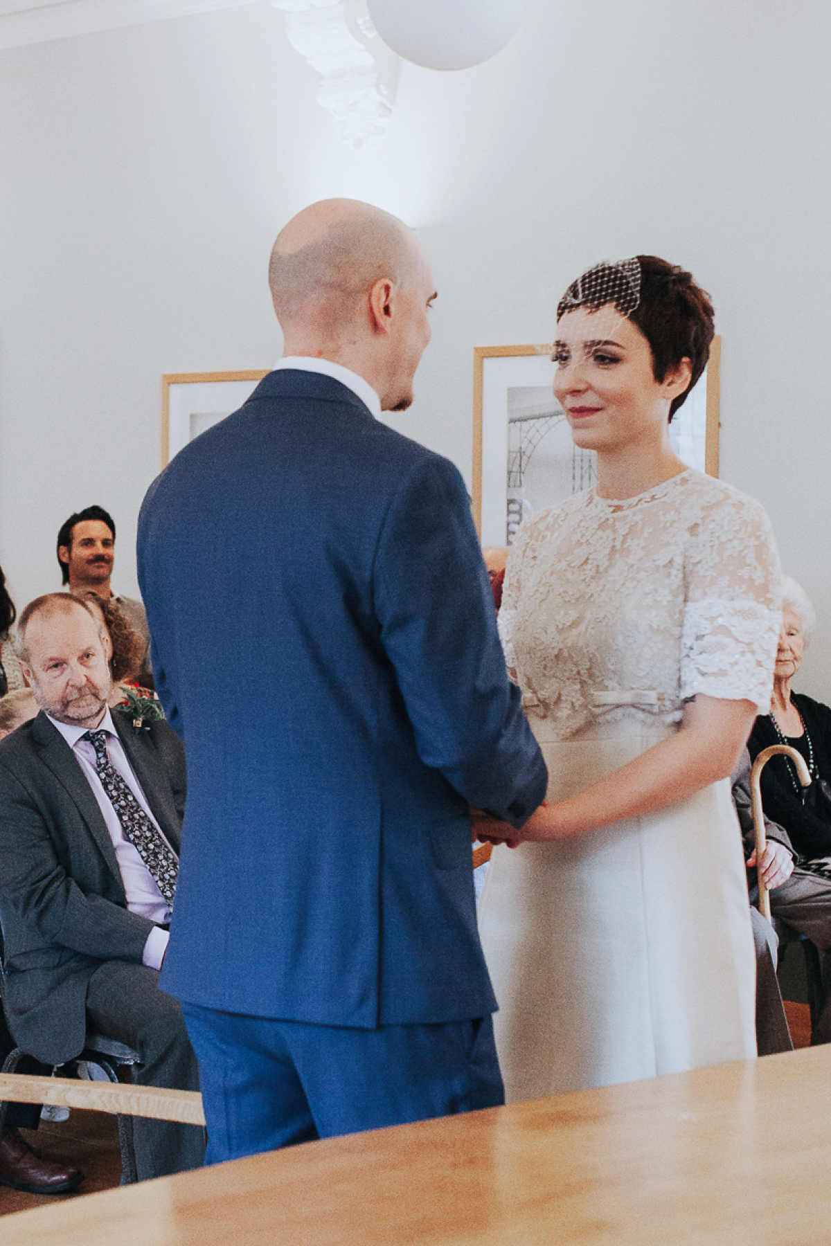 A short wedding dress and birdcage veil for a 1960's inspired bride. Image by Indie Photography.