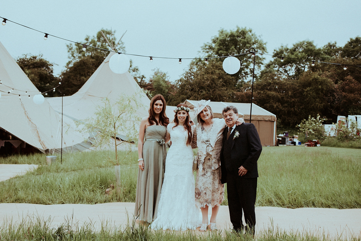 Alice wore an Essense of Australia gown for her rustic teepee wedding in North Yorkshire. Scandi teepees provided by Papakata, photography by Shutter Go Click.