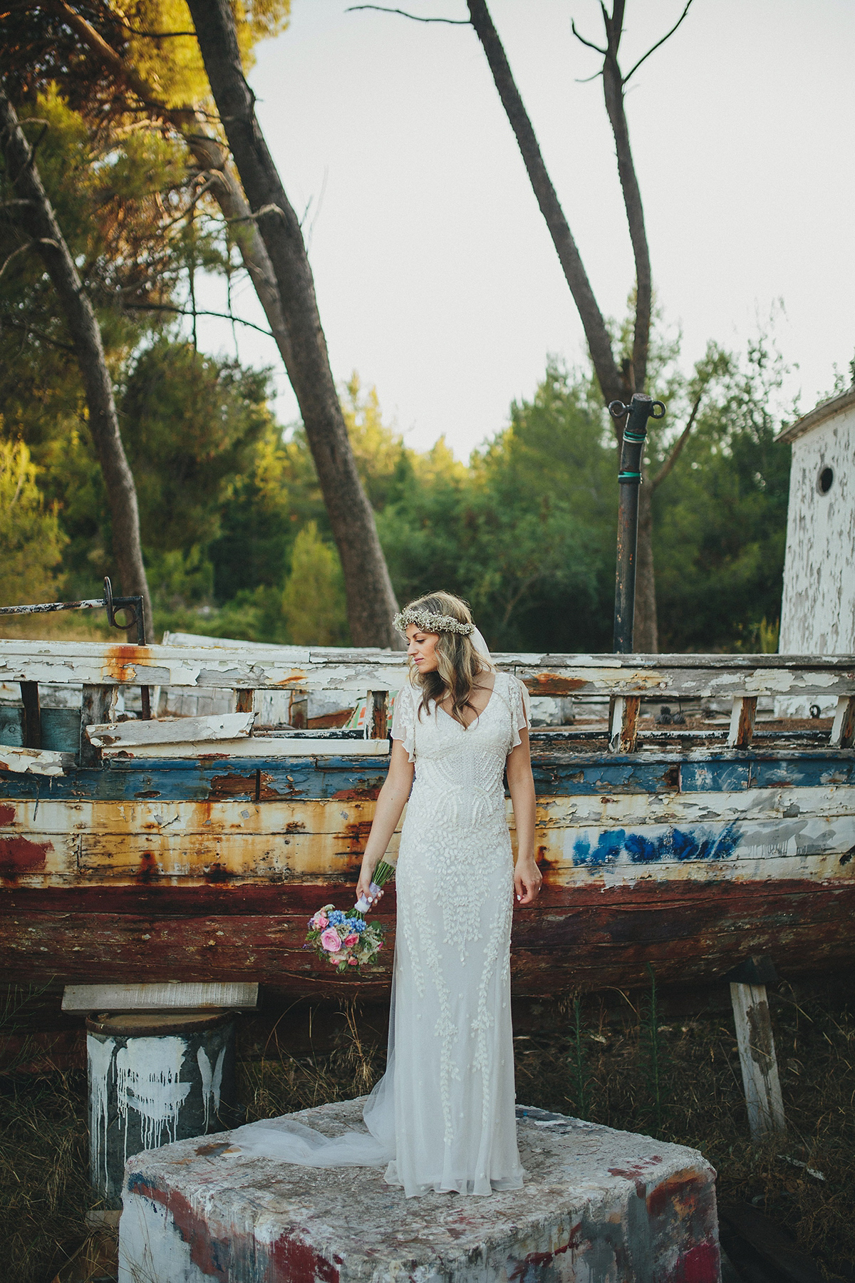 Bride Tamar wears an embellished Eliza Jane Howell gown and crown of gypsophila for her Croatian Island wedding. Photography by Petar Jurica.