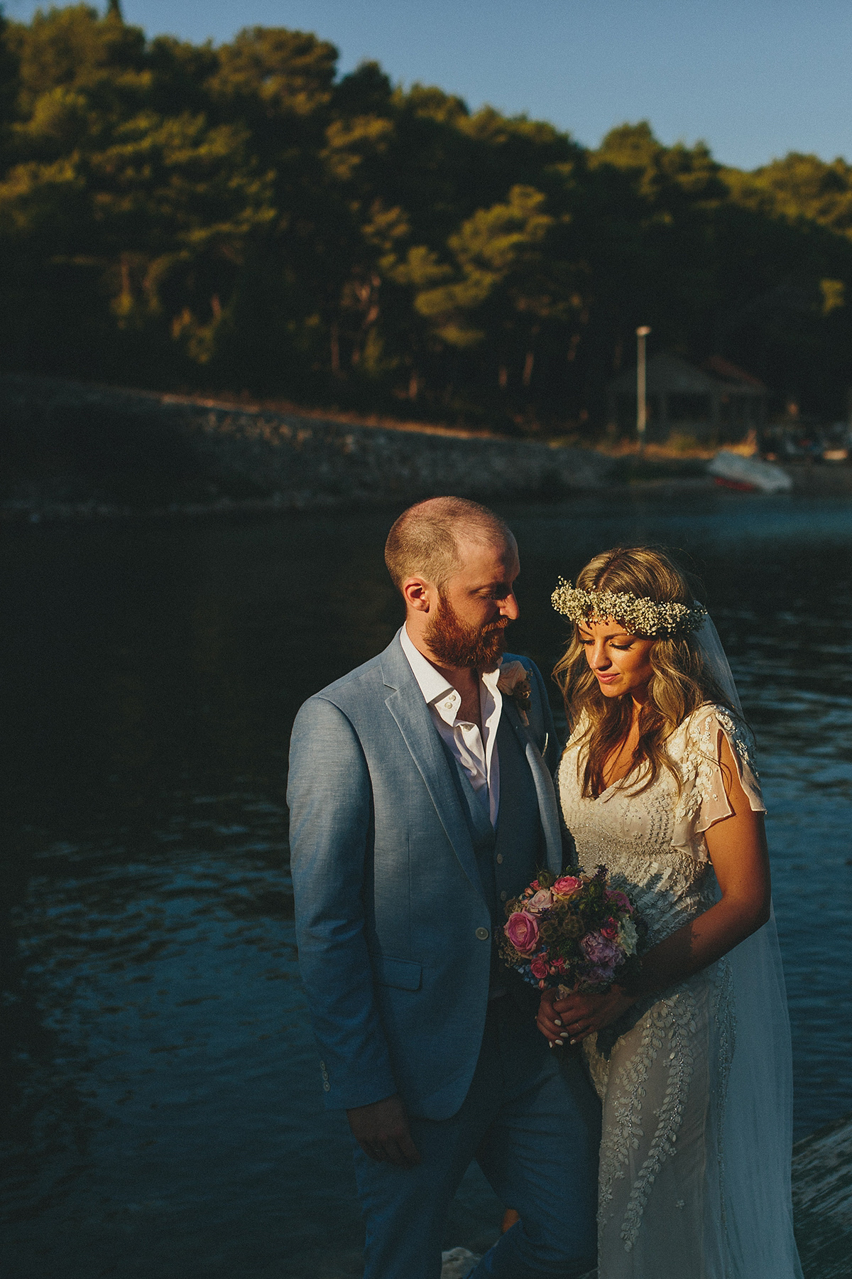 Bride Tamar wears an embellished Eliza Jane Howell gown and crown of gypsophila for her Croatian Island wedding. Photography by Petar Jurica.