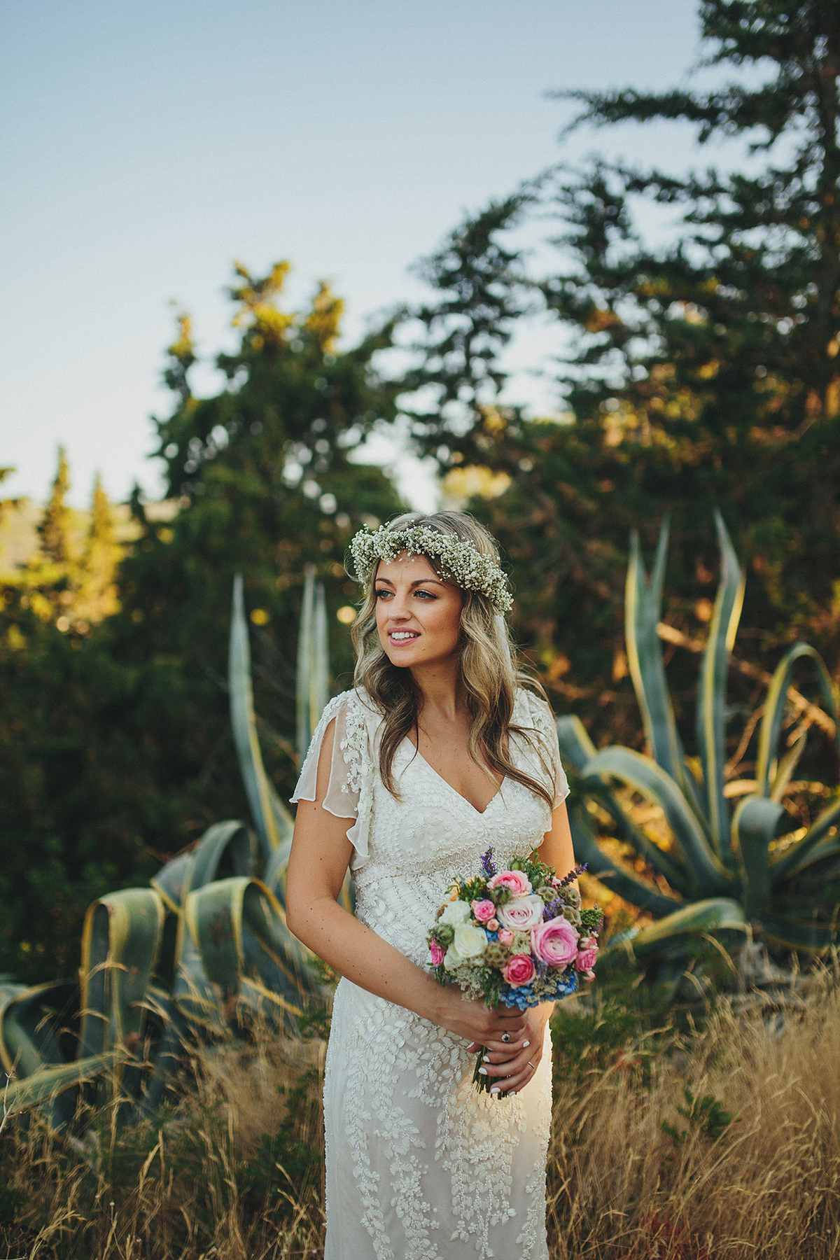 Bride Tamar wears an embellished Eliza Jane Howell gown and crown of gypsophila for her Croatian Island wedding. Photography by Petar Jurica.