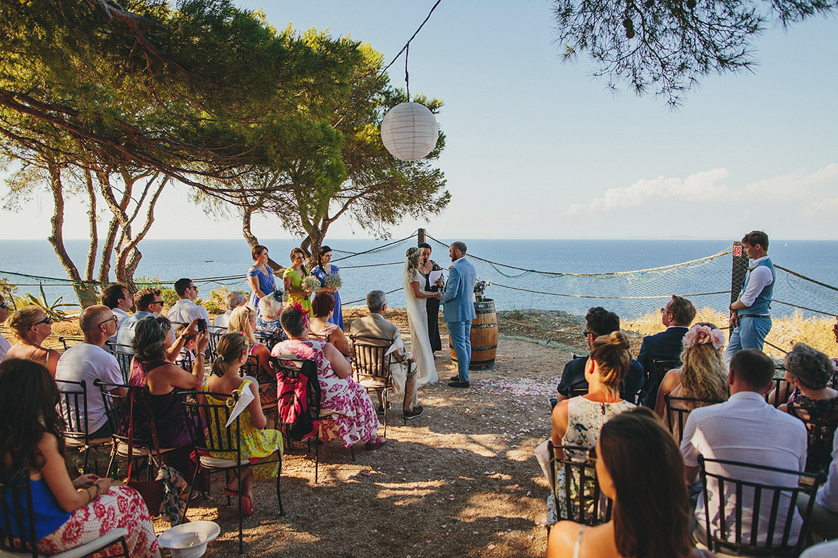 Bride Tamar wears an embellished Eliza Jane Howell gown and crown of gypsophila for her Croatian Island wedding. Photography by Petar Jurica.