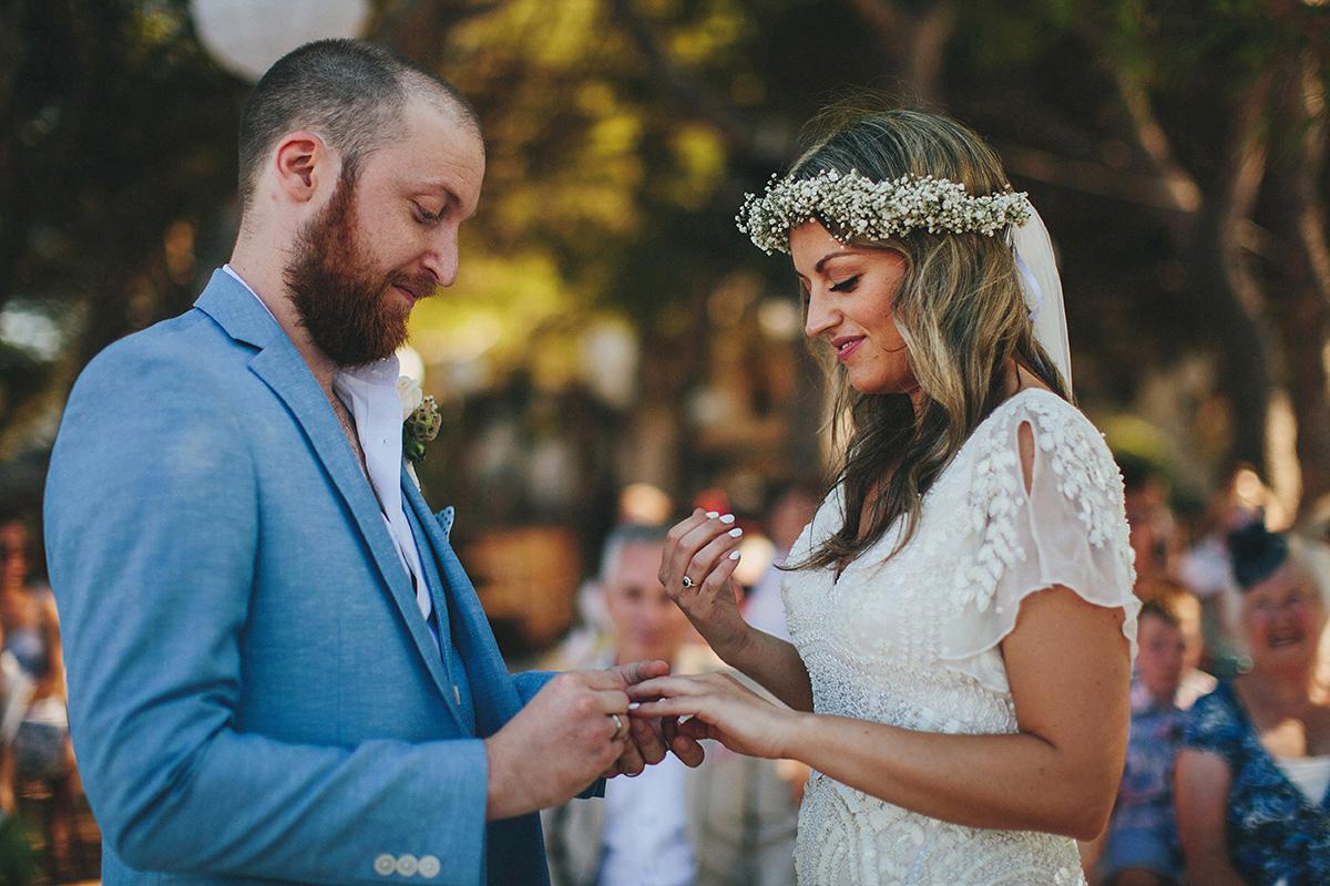 Bride Tamar wears an embellished Eliza Jane Howell gown and crown of gypsophila for her Croatian Island wedding. Photography by Petar Jurica.