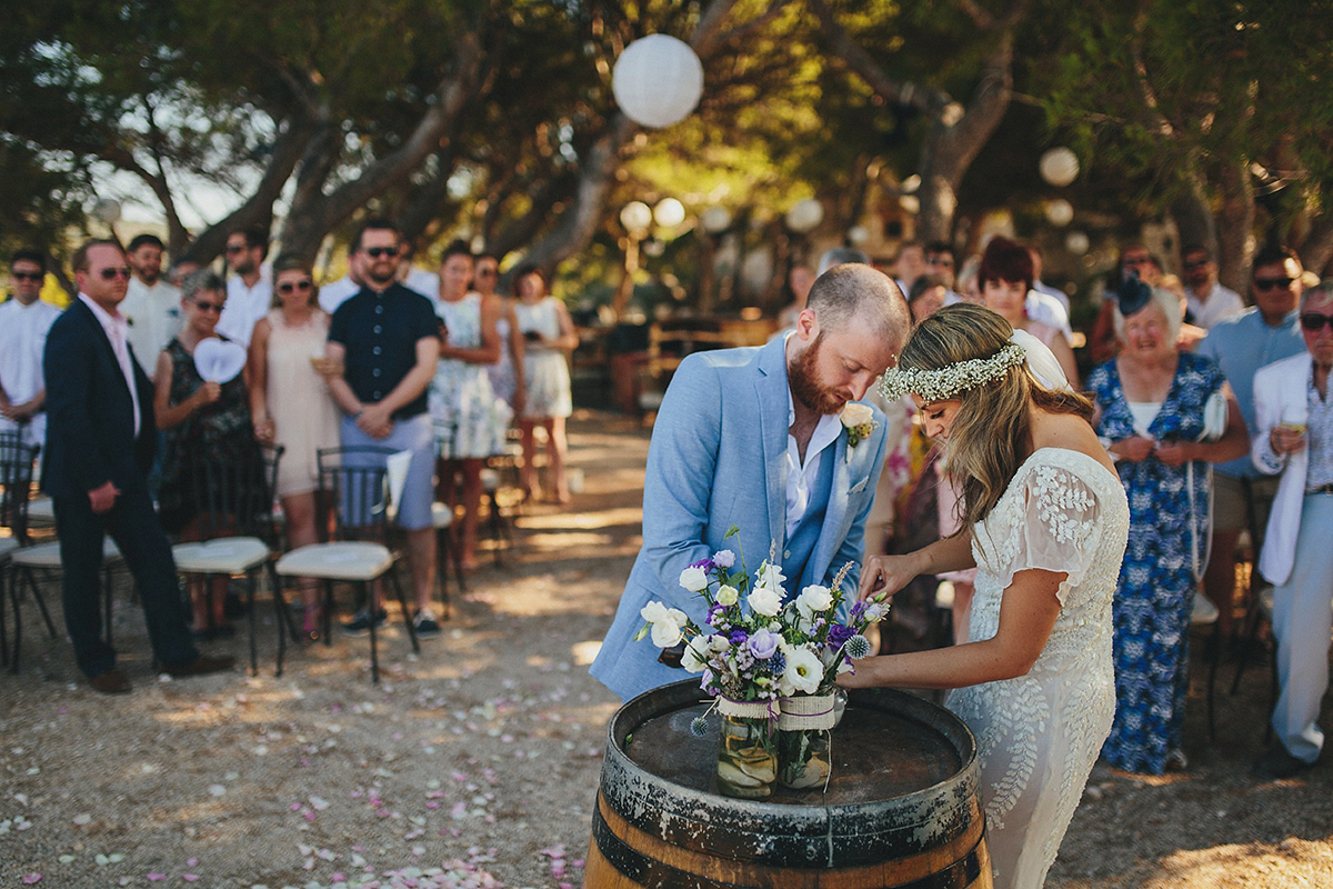 Bride Tamar wears an embellished Eliza Jane Howell gown and crown of gypsophila for her Croatian Island wedding. Photography by Petar Jurica.