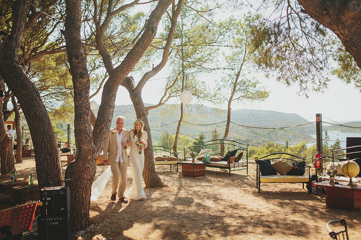 Bride Tamar wears an embellished Eliza Jane Howell gown and crown of gypsophila for her Croatian Island wedding. Photography by Petar Jurica.