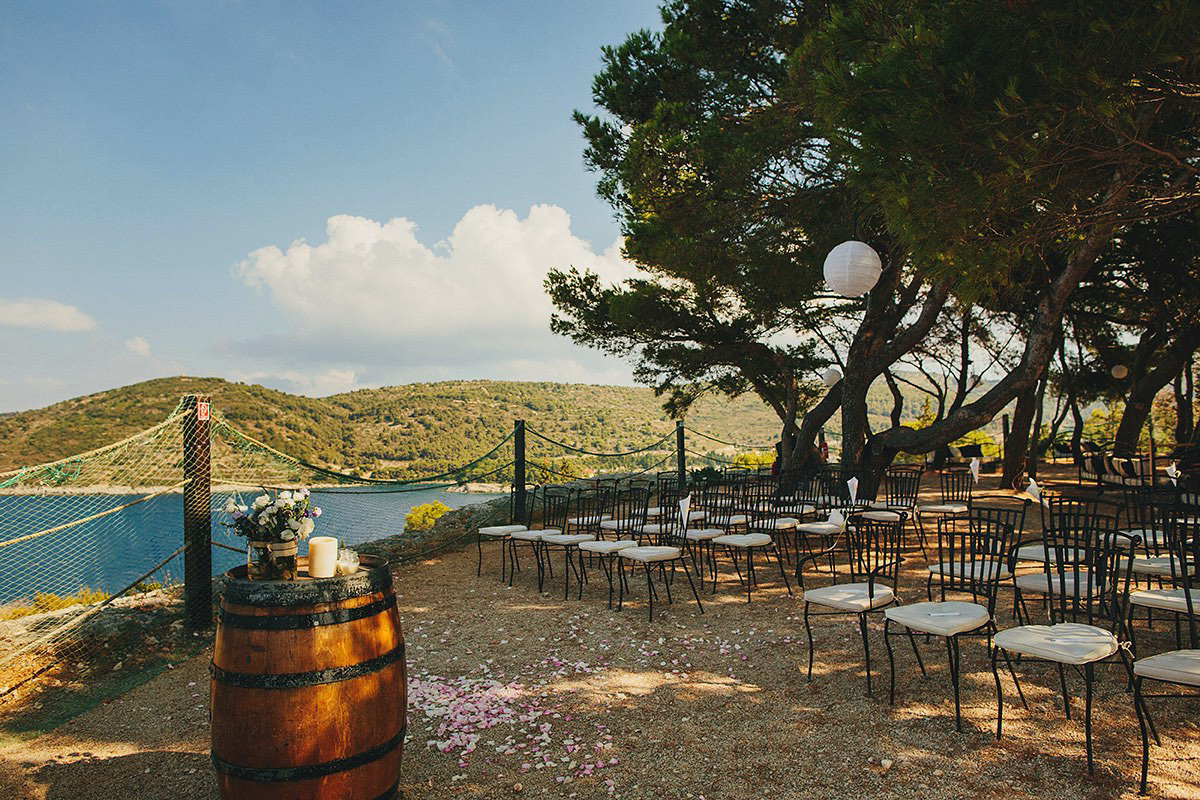 Bride Tamar wears an embellished Eliza Jane Howell gown and crown of gypsophila for her Croatian Island wedding. Photography by Petar Jurica.