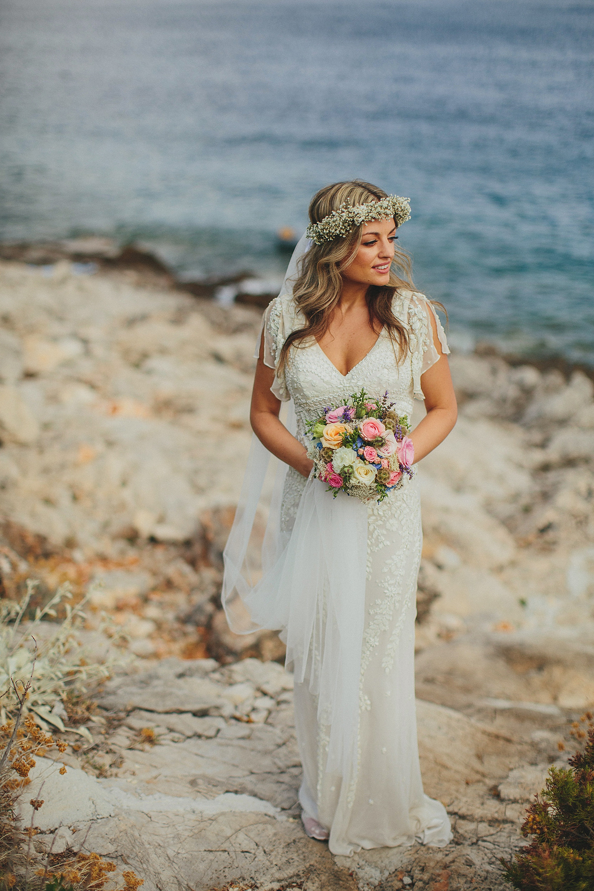 Bride Tamar wears an embellished Eliza Jane Howell gown and crown of gypsophila for her Croatian Island wedding. Photography by Petar Jurica.