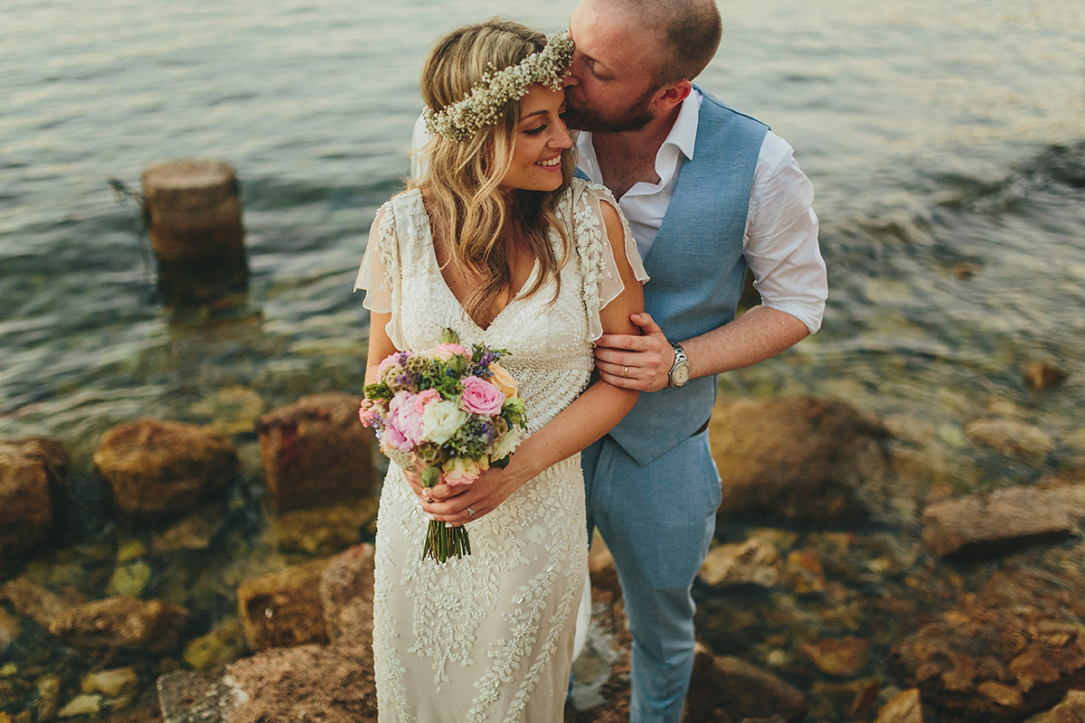 Bride Tamar wears an embellished Eliza Jane Howell gown and crown of gypsophila for her Croatian Island wedding. Photography by Petar Jurica.