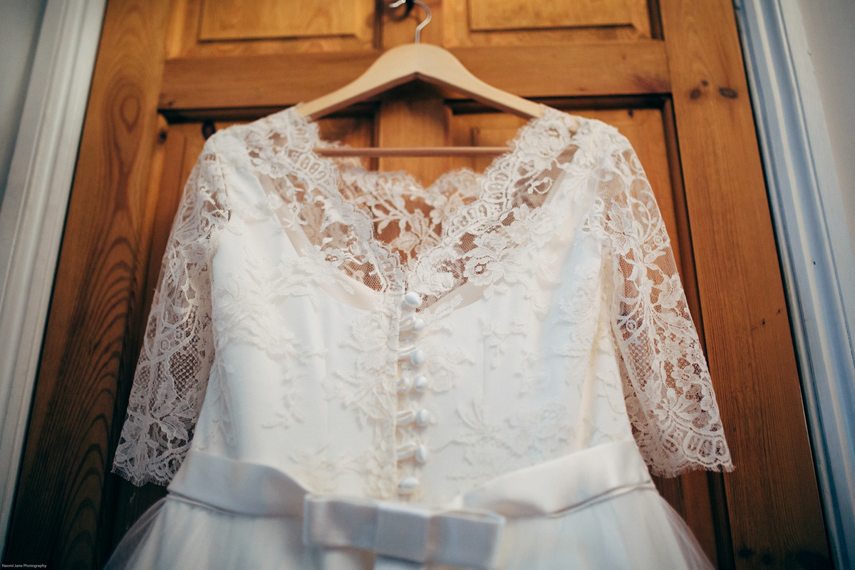 Bride Dany wears a 1950's inspired lace dress and birdcage veil for her modern cool wedding at The Asylum. Their reception was held in a London pub. Photography by Naomi Jane.