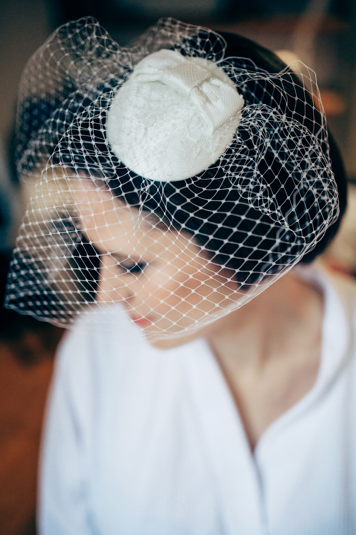 Bride Dany wears a 1950's inspired lace dress and birdcage veil for her modern cool wedding at The Asylum. Their reception was held in a London pub. Photography by Naomi Jane.