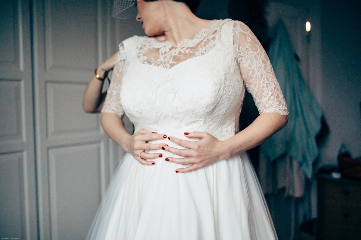 Bride Dany wears a 1950's inspired lace dress and birdcage veil for her modern cool wedding at The Asylum. Their reception was held in a London pub. Photography by Naomi Jane.