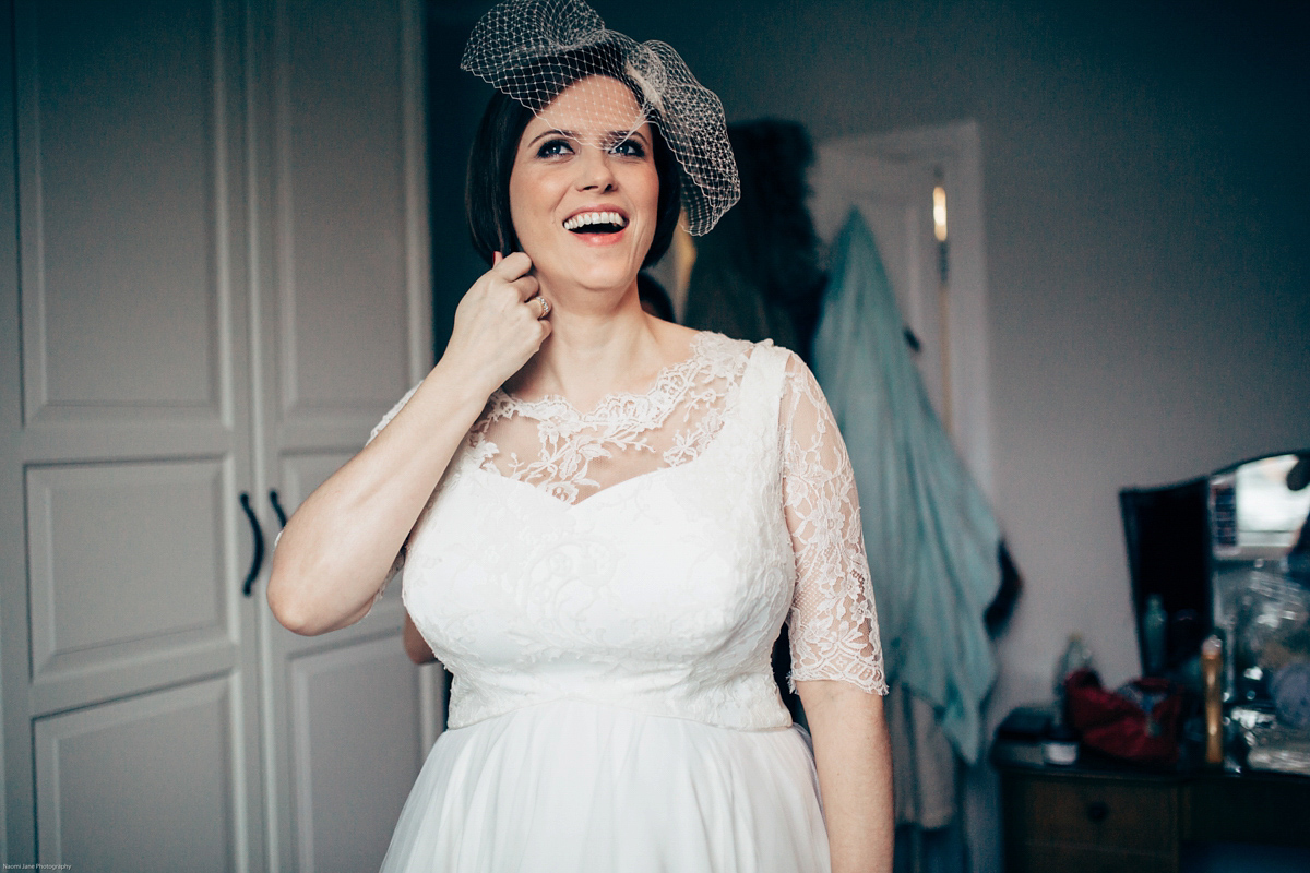 Bride Dany wears a 1950's inspired lace dress and birdcage veil for her modern cool wedding at The Asylum. Their reception was held in a London pub. Photography by Naomi Jane.