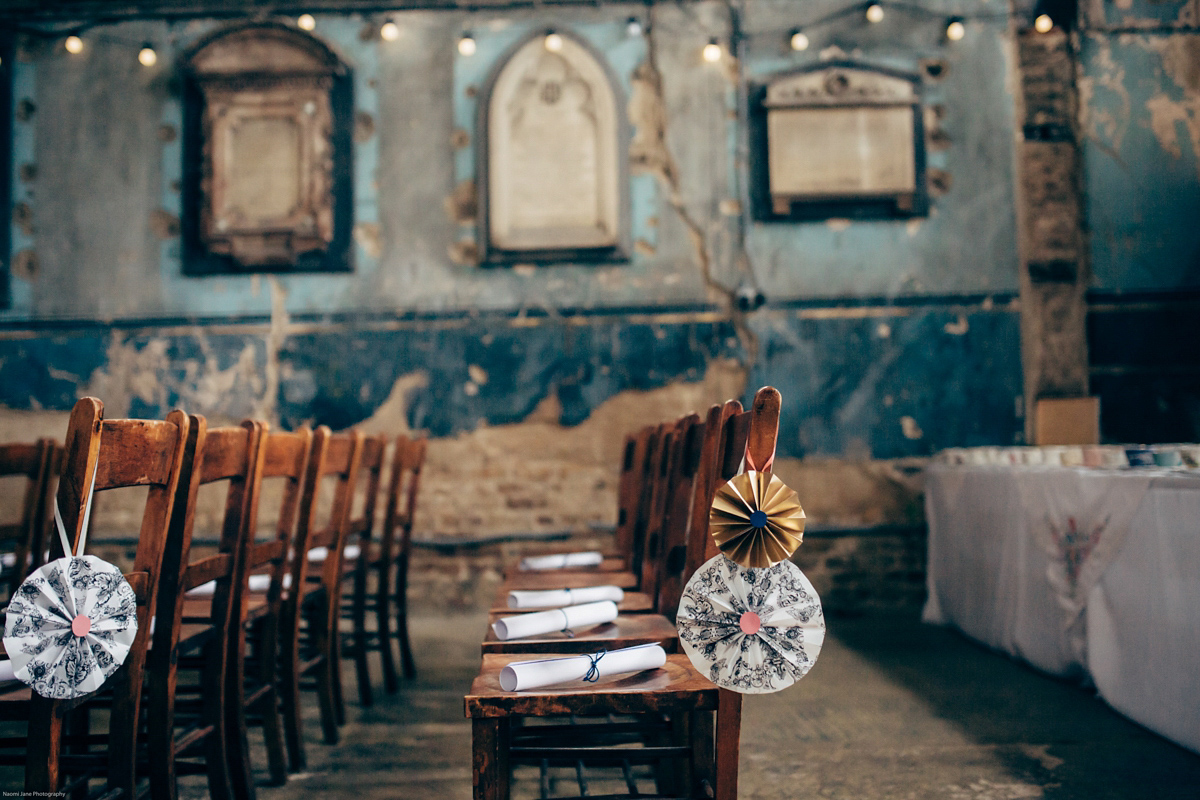 Bride Dany wears a 1950's inspired lace dress and birdcage veil for her modern cool wedding at The Asylum. Their reception was held in a London pub. Photography by Naomi Jane.