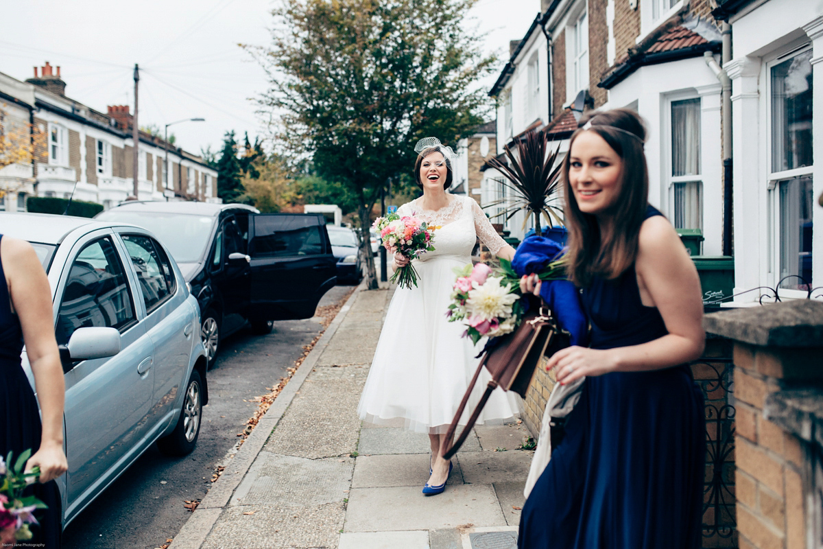 Bride Dany wears a 1950's inspired lace dress and birdcage veil for her modern cool wedding at The Asylum. Their reception was held in a London pub. Photography by Naomi Jane.